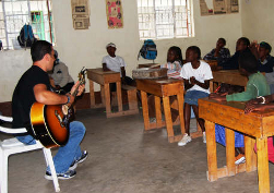 A volunteer serenades the kids at Jubilee Children's Center