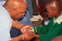 A volunteer holds hands and connects with a child