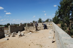 Volunteers build brick walls for Phase 1 of the high school