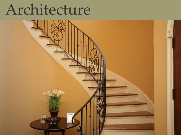 A dramatic sprial staircase with wrought iron railing